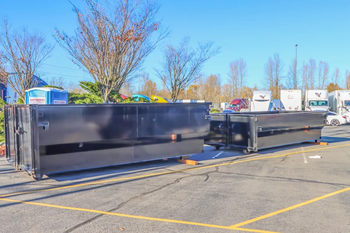 Professional dumpster rental service with roll-off container on residential driveway in Grambling